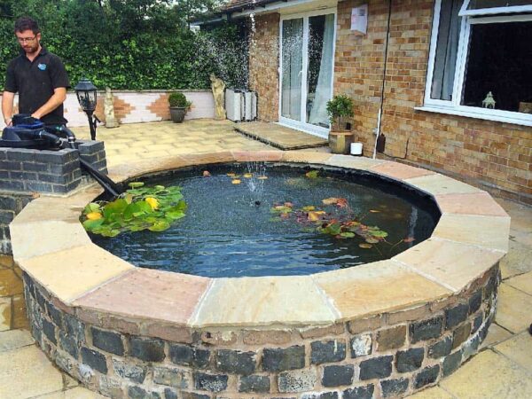 Raised circular pond after refurbishment and filtration — Grantham, JDM Ponds